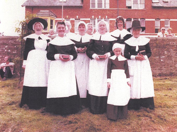 Pilton Women's Institute at Pilton Festival as Puritans probably in 1982