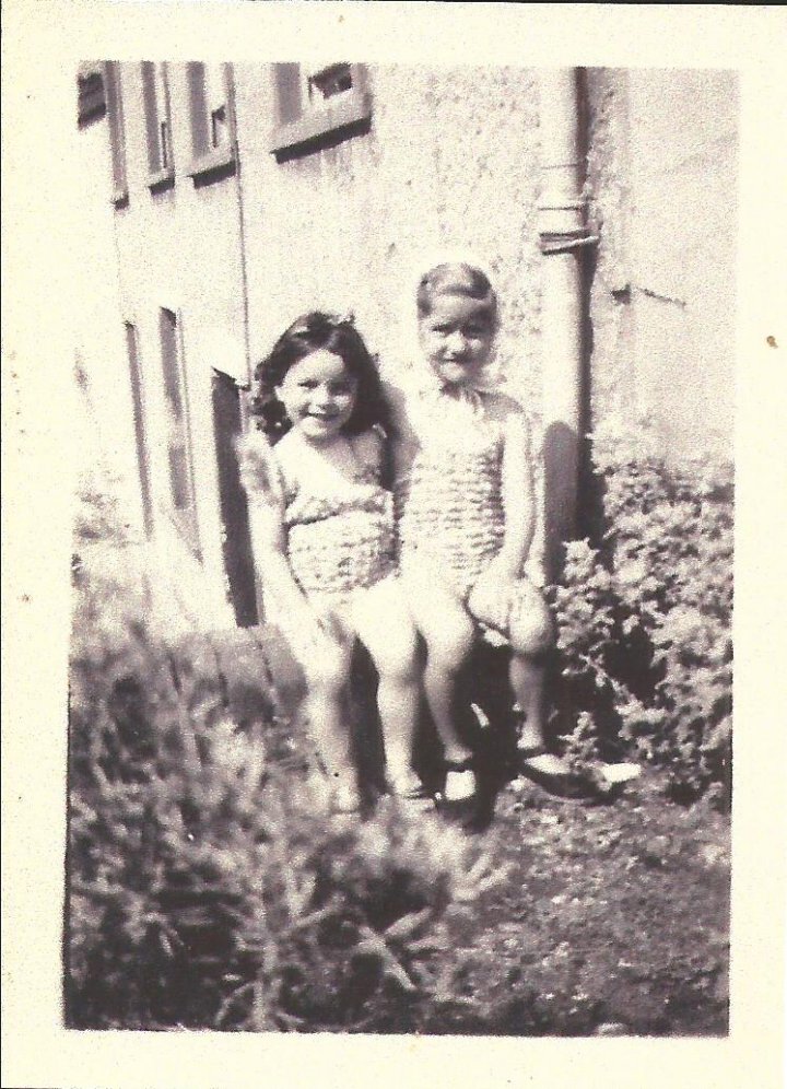 Gillian Blake and Shirley Squire sitting on the wall at 50 The Rock, Pilton in 1947